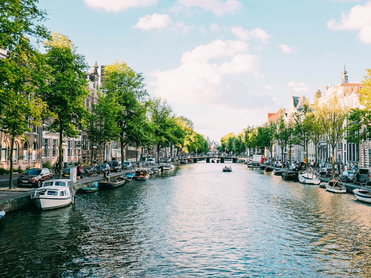Historic canal houses and boats on a sunny morning